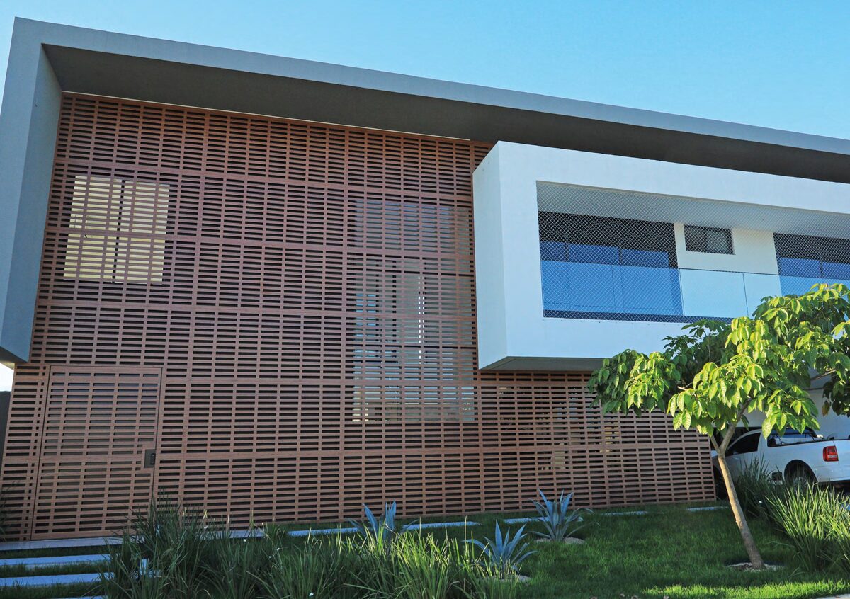 Fachada de vivienda con panel calado en ACM símil madera